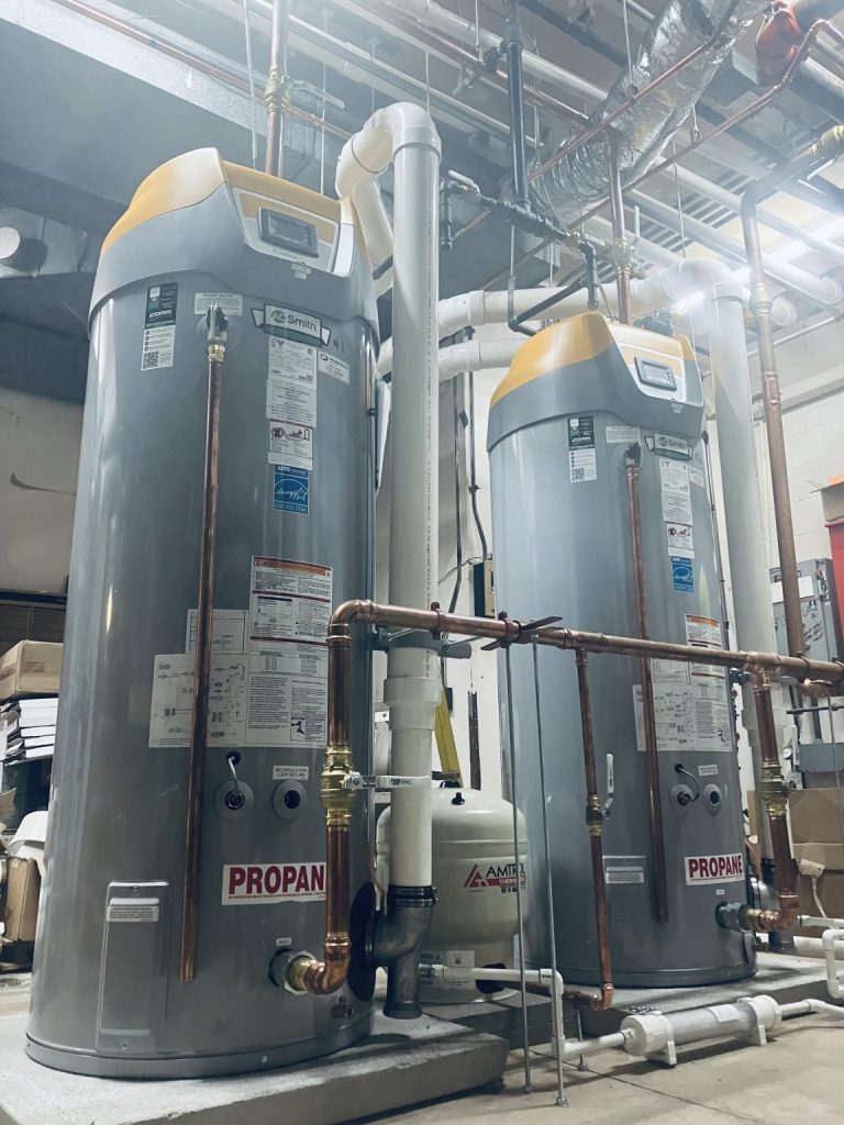Two commercial water heaters with copper supply lines