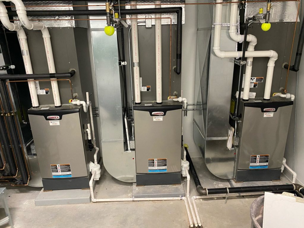 Three Lennox furnaces installed side by side in the Bell Bank mechanical room