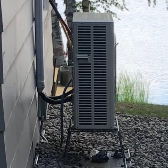 Mitsubishi mini-split outdoor unit installed on a lake home in Cotton, MN