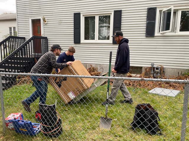 Carlson crew carrying a new furnace into the Lincoln Park Children and Family Collaborative